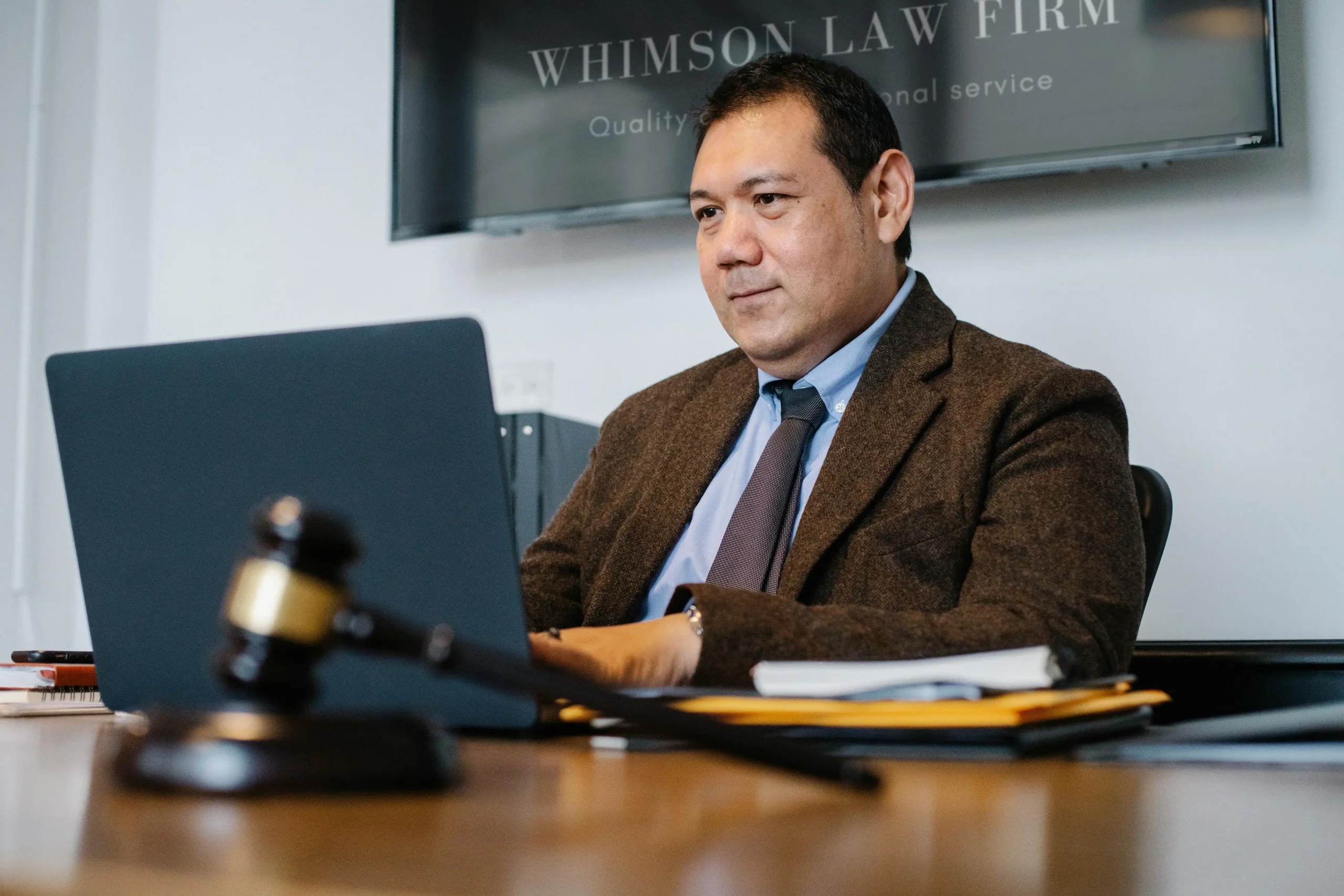 Gentleman working on his laptop in a law firm setting