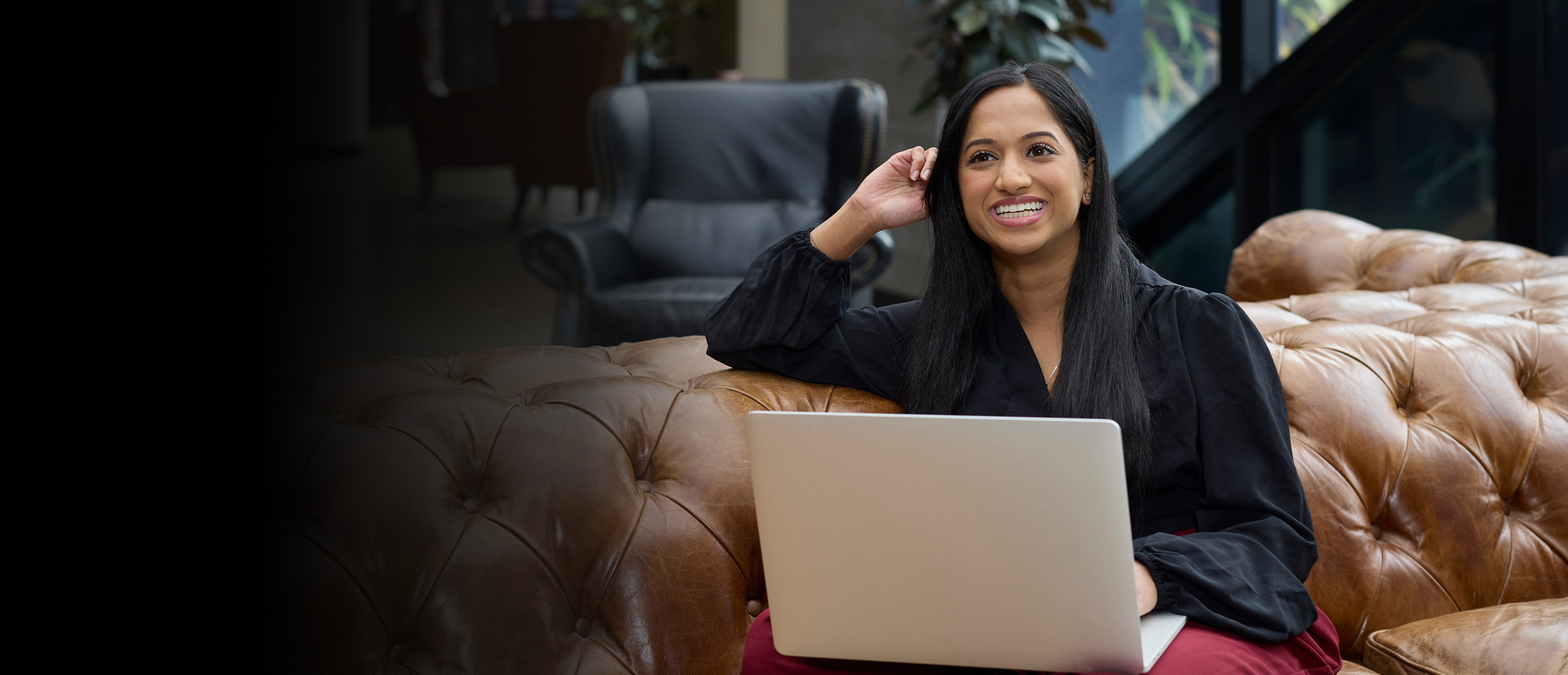 Young woman smiling professional on couch.