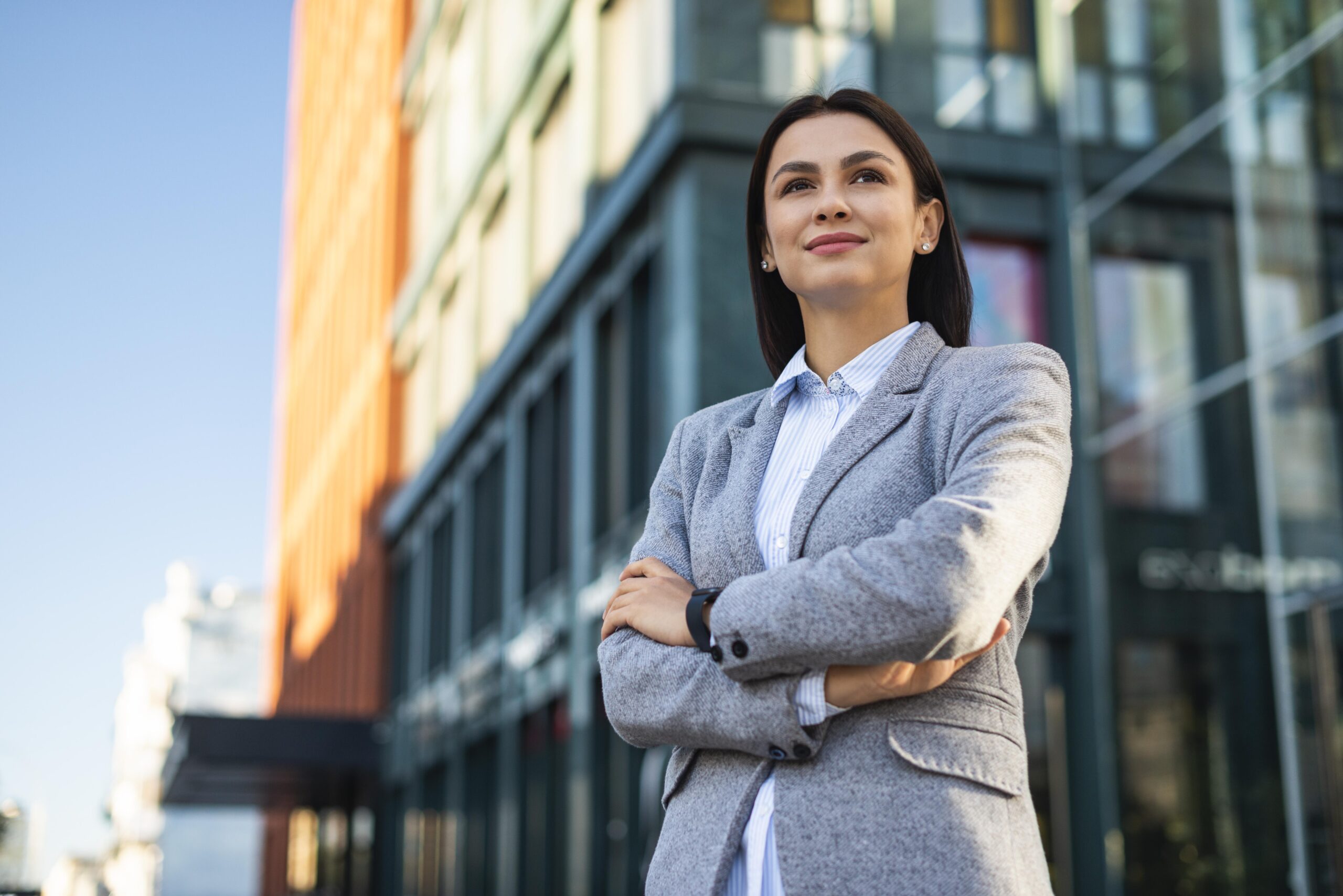 Young professional woman standing in front of building.