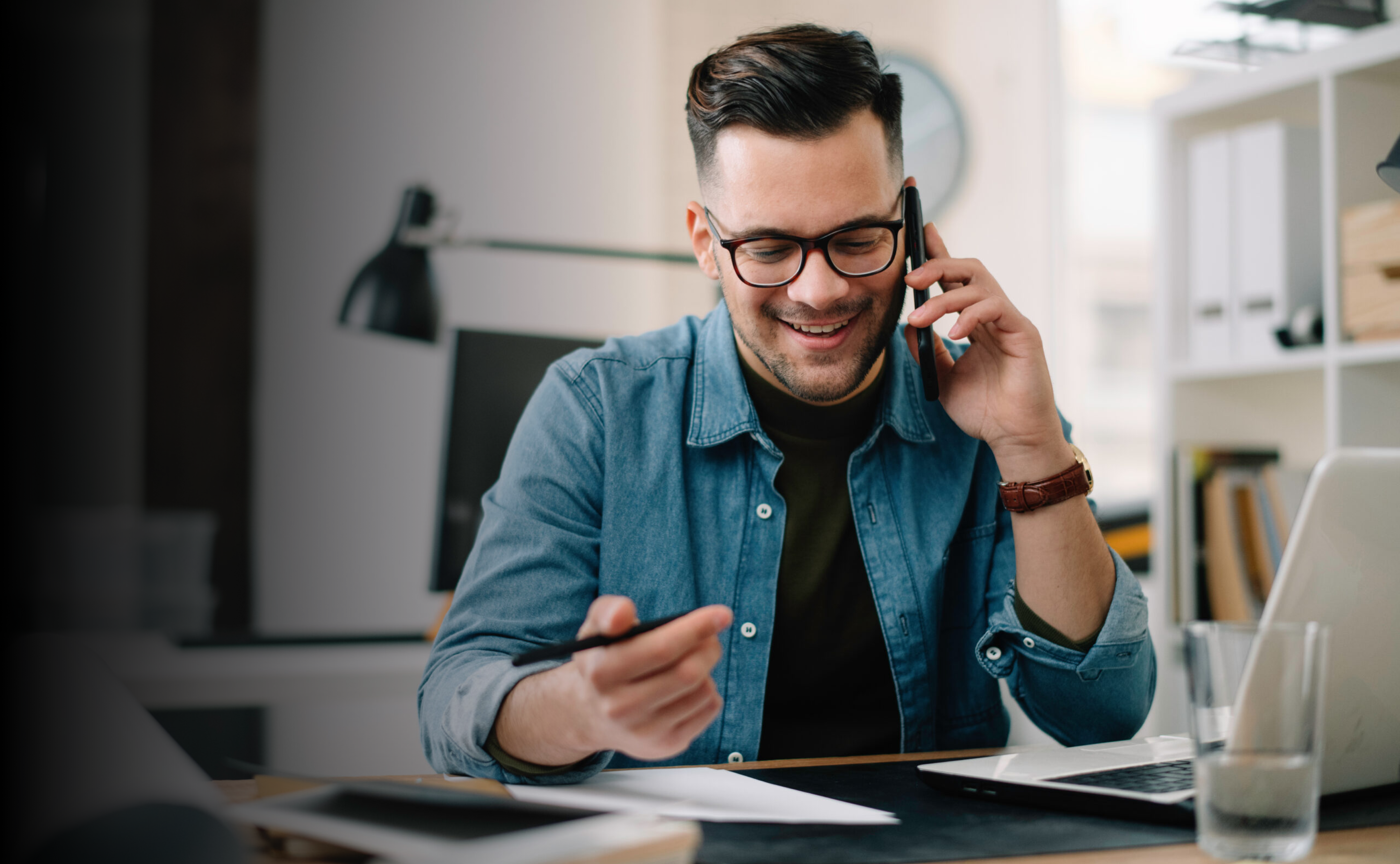 Man on phone with laptop