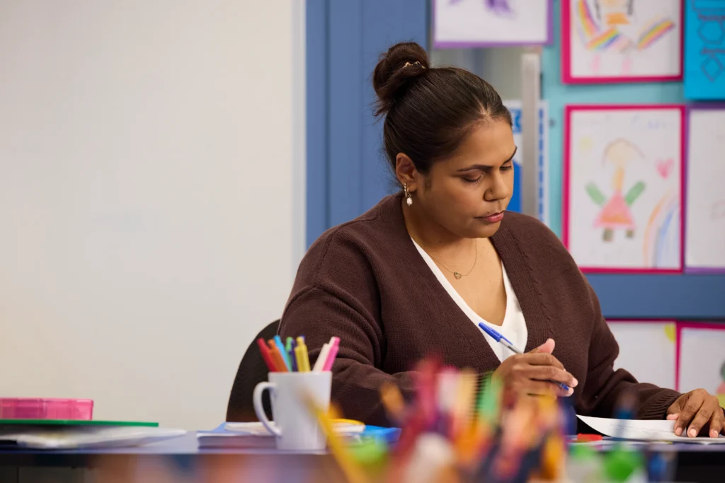 managing behaviour in primary classrooms —a teacher planning a lesson alone in her classroom.